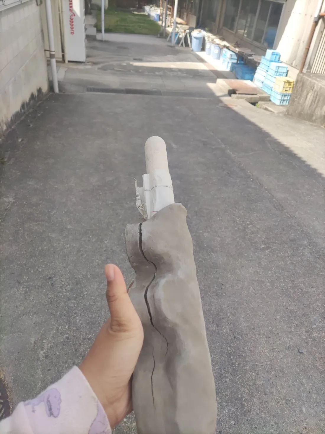 A raw clay form, in the studio alley