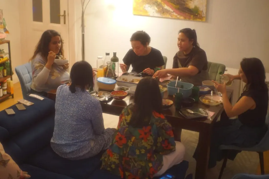 Guests gathered around the table at a community dinner