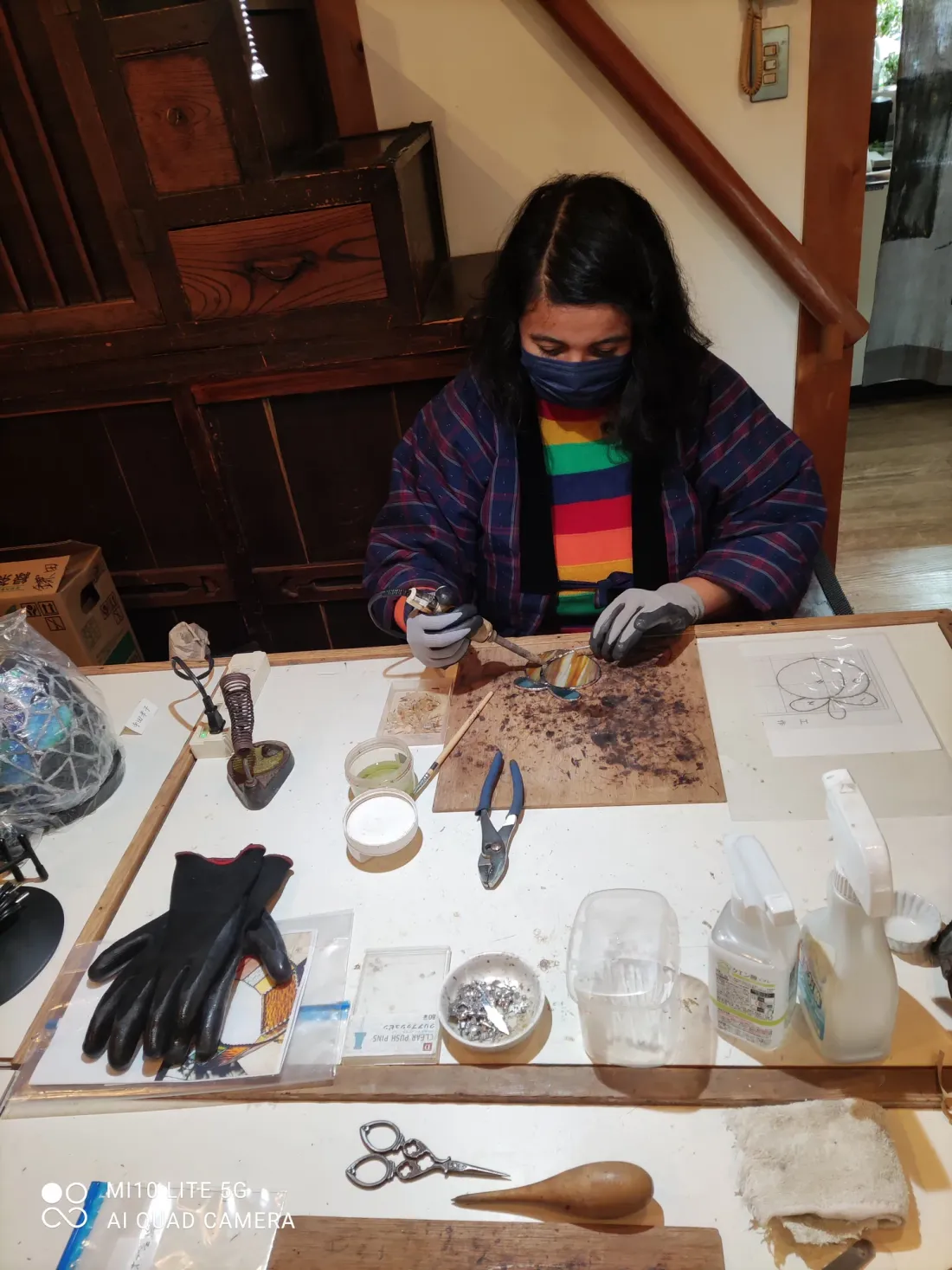 At the bench, working stained glass